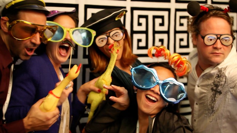 Image: Attendees at ONA's opening reception smile for a photo booth camera at the Rincon Center in San Francisco Thursday night. (Photo by Jill Knight)