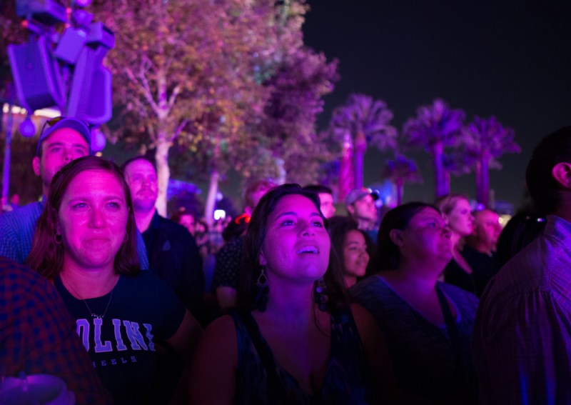 University of North Carolina multimedia student Rocio Sevilla Dieguez, center, watches the Water of Color light show at California Adventures with UNC graduate student Kiersten Schmidt, left. The North Carolina journalism students were part of an Online News Association contingent attending a pre-conference tour of the Disney theme park. (Haiyun Jiang/ONA Student Newsroom)