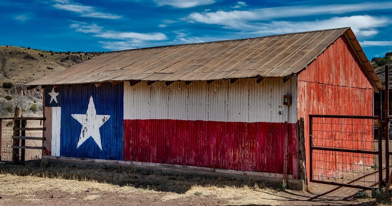 Metal side of a barn, decorated with a painting of the Flag of Texas, near Fort Davis in Jeff Davis County, Texas.